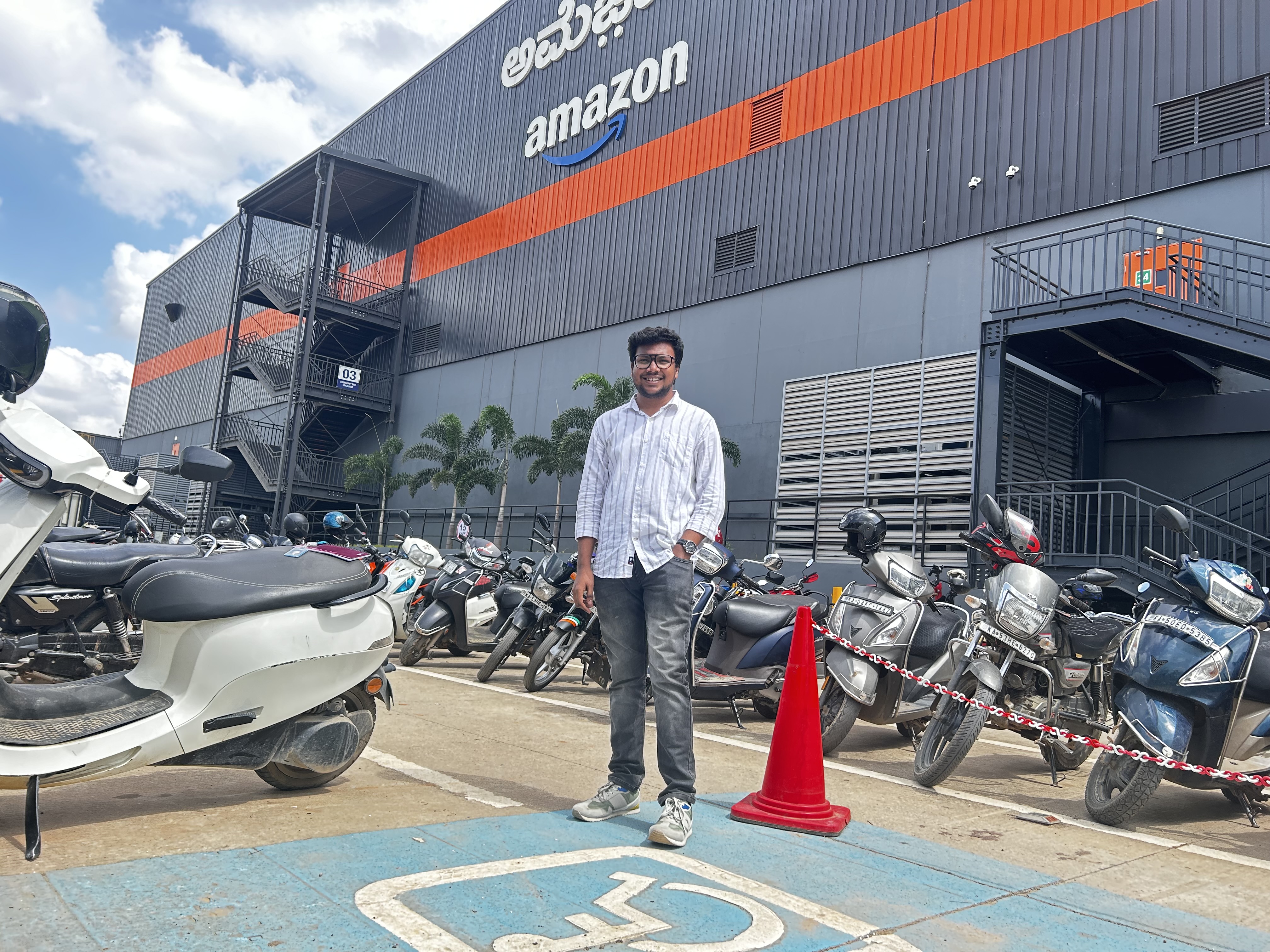 Shabul Hussain standing outside Amazon office building