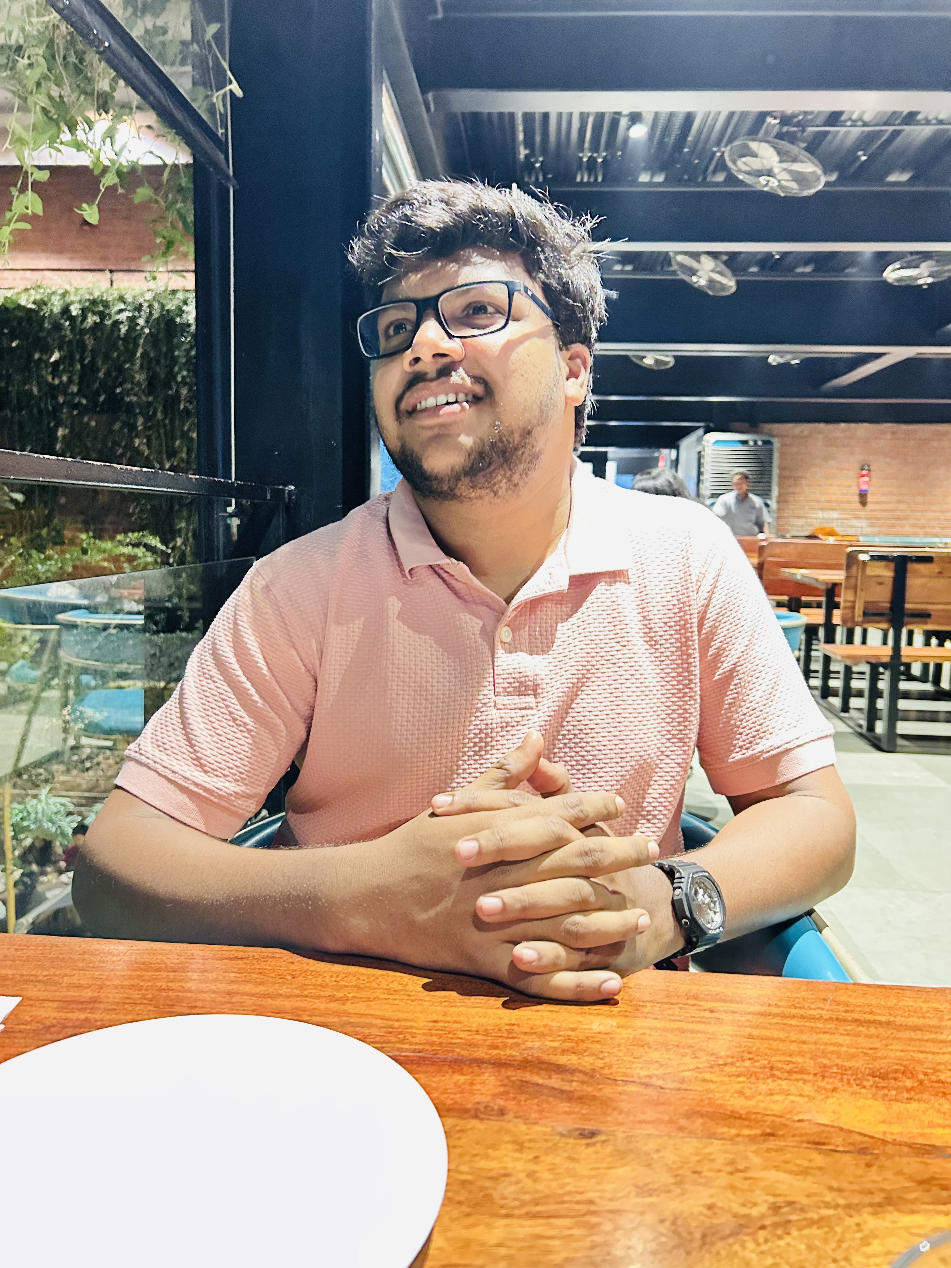 Shabul Hussain relaxed at restaurant in pink polo